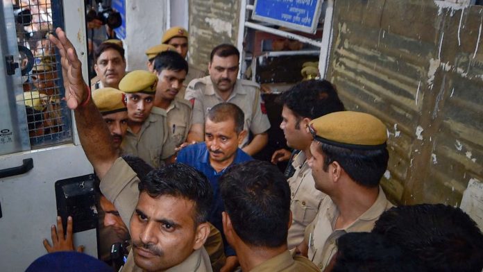 ஆகஸ்ட் 5, 2019 அன்று புது தில்லியில் உள்ள திஸ் ஹசாரி நீதிமன்றத்தில் நடந்த விசாரணைக்குப் பிறகு குல்தீப் சிங் செங்கார் திகார் சிறைக்கு அழைத்துச் செல்லப்பட்டார் | ரவி சௌத்ரி | PTI கோப்பு புகைப்படம்